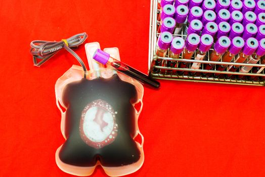 Close up bag of blood and plasma and rubber tube isolated on Red background