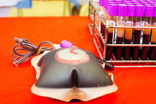 Close up bag of blood and plasma and rubber tube isolated on Red background