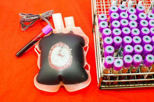 Close up bag of blood and plasma and rubber tube isolated on Red background