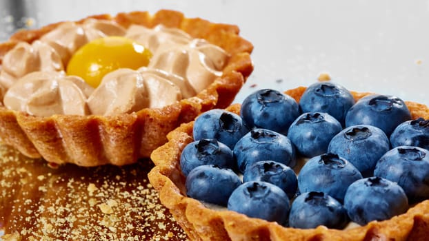 Tartlet with fresh blueberries. Background with copy space.