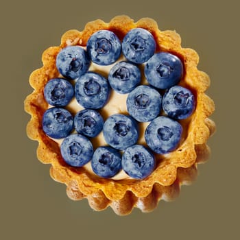 Tartlet with fresh blueberries. Background with copy space.