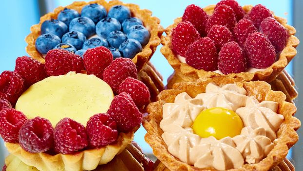 fruit tartlets with raspberries and blueberries. with copy space