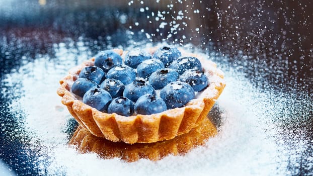 Tartlet with fresh blueberries. Background with copy space.