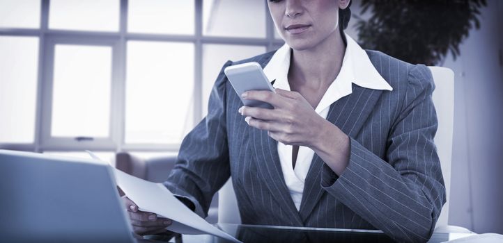 Businesswoman using her smartphone in an office