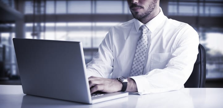 Cheerful businessman using laptop at desk on white background