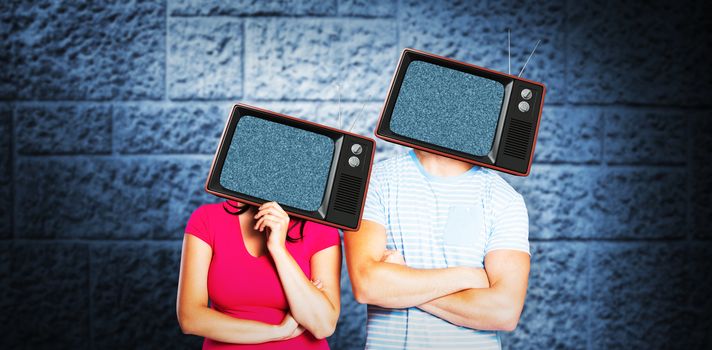 Young couple with bags over heads against dark grey room