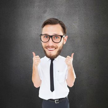 Geeky businessman with thumbs up against grey room