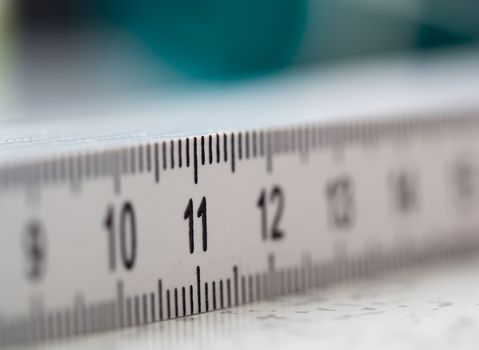 Extreme closeup macro shot of number 11 on a white plastic ruler
