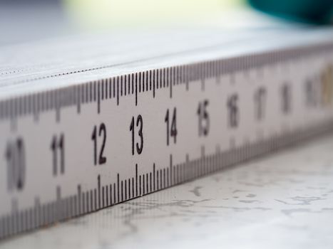Creative macro shot with focus on numer 13 on a white plastic ruler