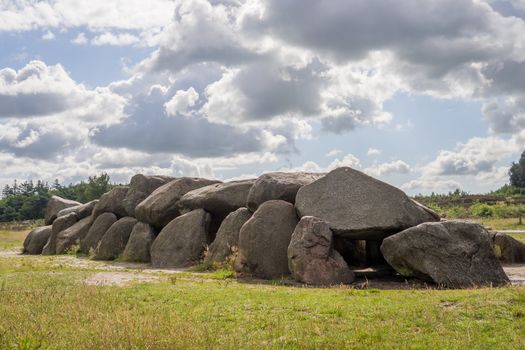 Sunny HDR of megalithic stones in Drenthe, Netherlands, with a dramatic sky above
