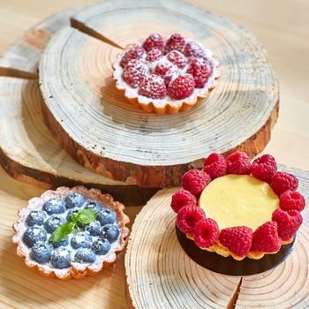 fruit tartlets with raspberries and blueberries. with copy space