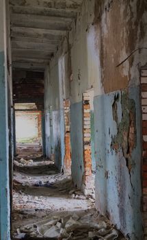 long corridor in a crumbling brick building