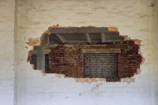 the hole in the brick wall of the ruined building