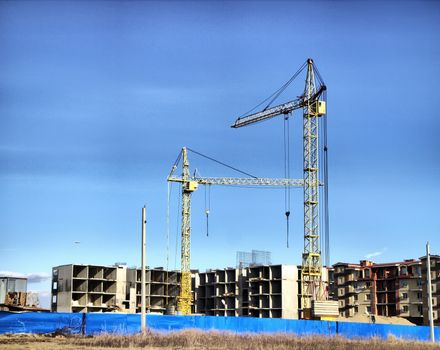 construction site with cranes for multi-family homes