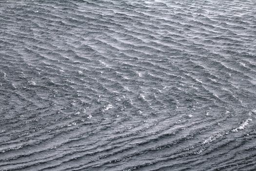High sharp waves in the Arctic sea. On the horizon of the Northern island of Novaya Zemlya