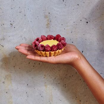 Dessert in a hand on a concrete background with copy space