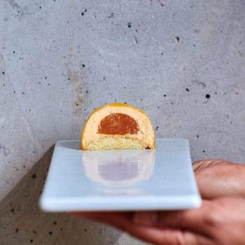 Dessert in a hand on a concrete background