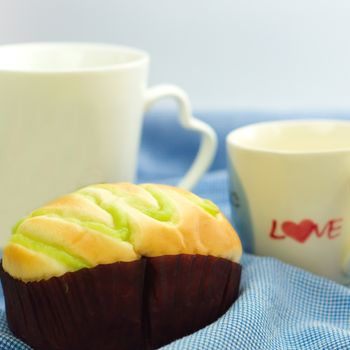 Bun and white coffee mug with word love on side