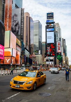 NEW YORK, USA - AUGUST 7, 2015: A yellow cab drives past Times Square.