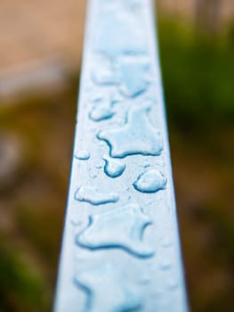 Decorative raindrops or water drops on a metal bar, soft focus