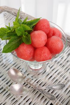 Refreshing appetizer of watermelon balls with mint leaves in a glass