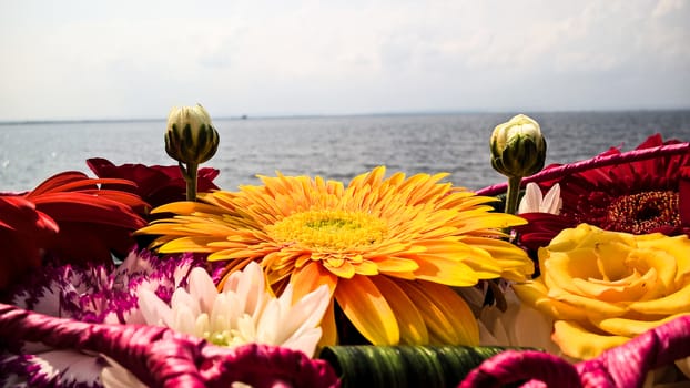 A basket of flowers on a lake background