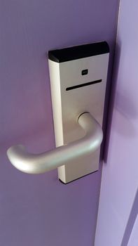 Magnetic Card Reader Door Lock on a purple door of a room in a hotel