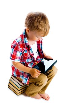 Little boy with a Tablet PC sitting on the books