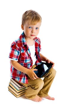 Little boy with a Tablet PC sitting on the books