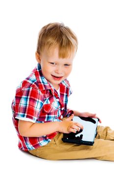Little boy with a Tablet PC sitting on the floor