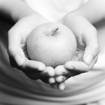 woman hand holding green apple fruit black and white color tone style