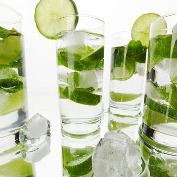 Mojito cocktails with lime and mint isolated on white background