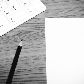 keyboard computee white paper and black pencil on wood background black and white color tone style