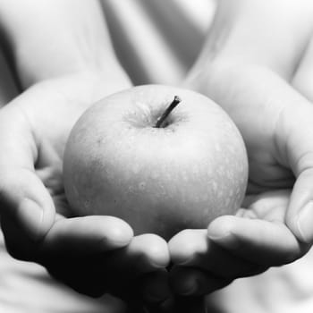 woman hand holding green apple fruit black and white color tone style