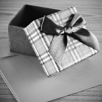 gift box and envelope on wood background black and white color tone style