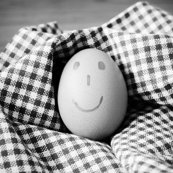 smile love egg couple in brown kitchen towel on wood table black and white color tone style