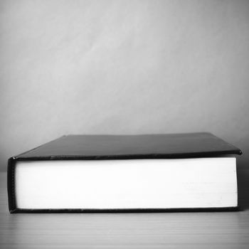 book on wood table background black and white color tone style