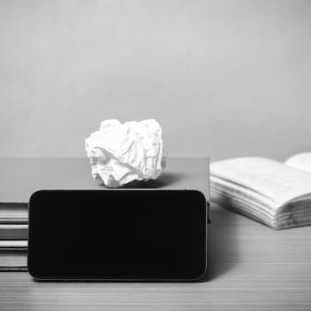 stack of book with smart phone on wood background black and white color tone style