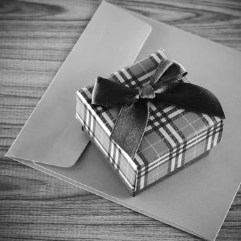 gift box and envelope on wood background black and white color tone style