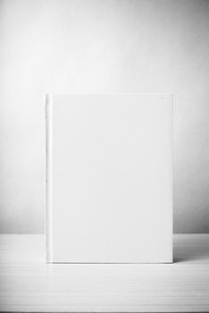 book on wood table background black and white color tone style