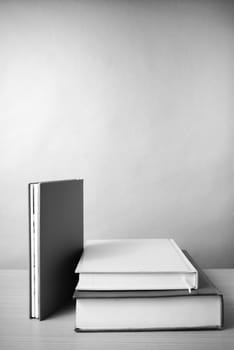 stack of book on wood table background black and white color tone style