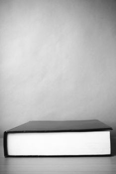 book on wood table background black and white color tone style