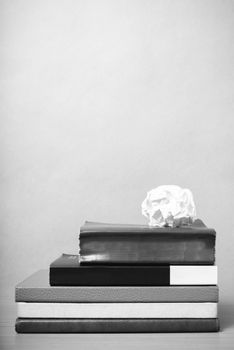 book and crumpled paper on wood background black and white color tone style