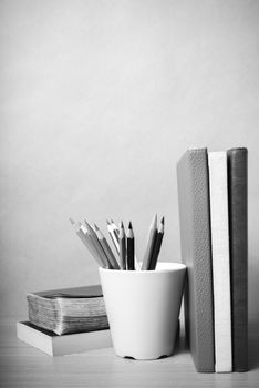 book and color pencil on wood background black and white color tone style