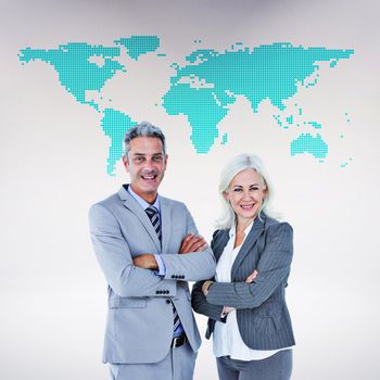 Smiling businesswoman and man with arms crossed against green world map on white background