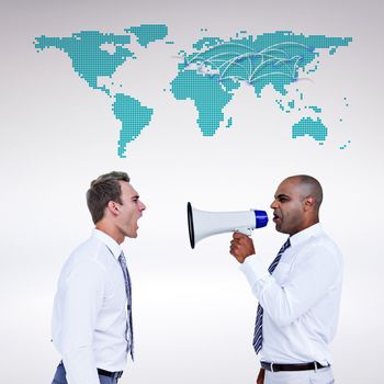 Businessman yelling with a megaphone at his colleague against world map 