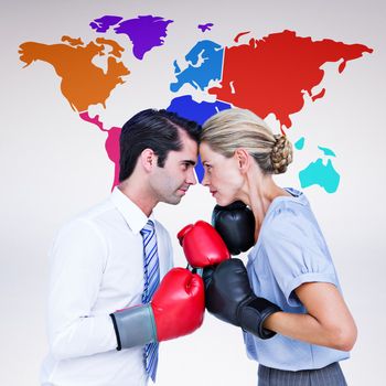 Business people wearing and boxing red gloves against grey background