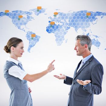 Business team arguing against world map 