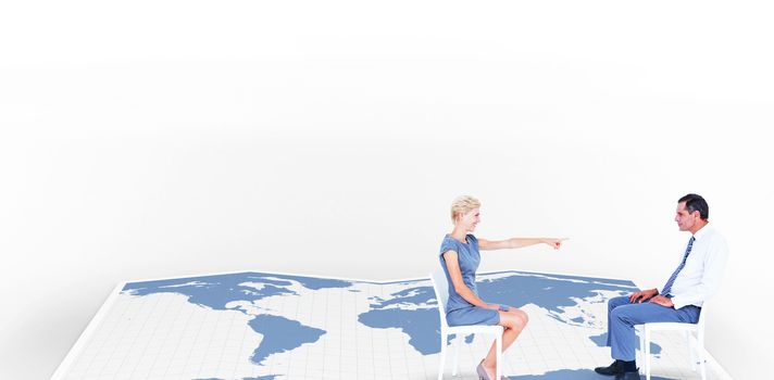 businesswoman pointing at businessman against world map