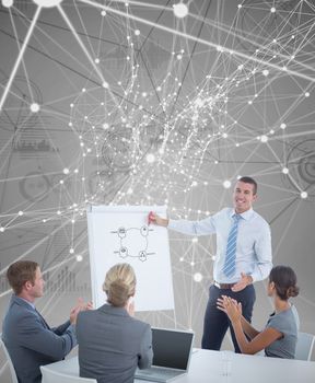 Manager presenting whiteboard to his colleagues against interface with graphs